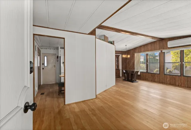 a view of a livingroom with a hall and wooden floor