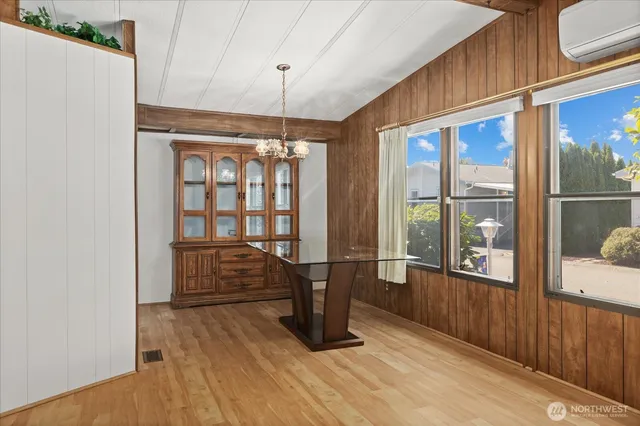 a view of a hallway with wooden floor and door