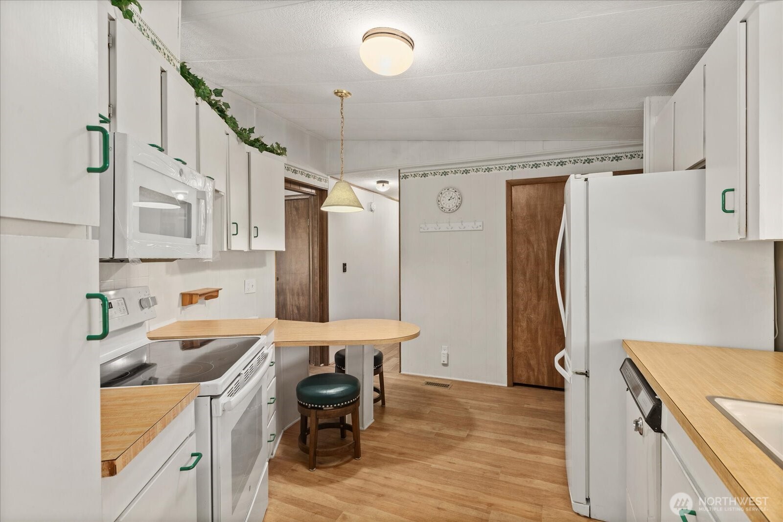 815 124th Street Southwest, Unit 133 Everett, WA 98204 - Photo 9 of 38 a kitchen that has a refrigerator a sink and a stove