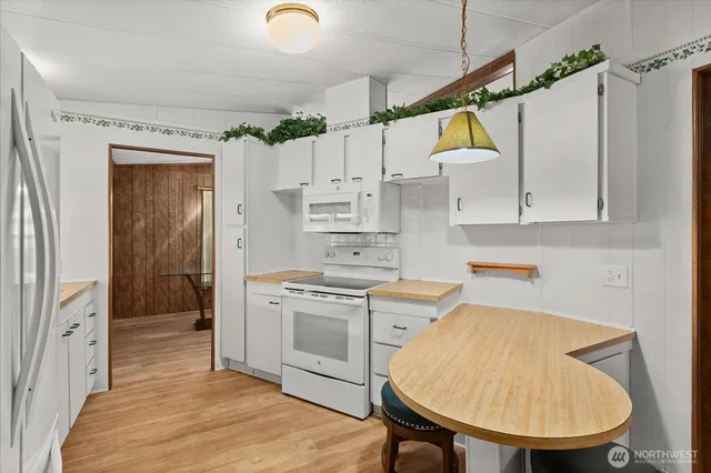 a view of a kitchen with a sink and cabinets