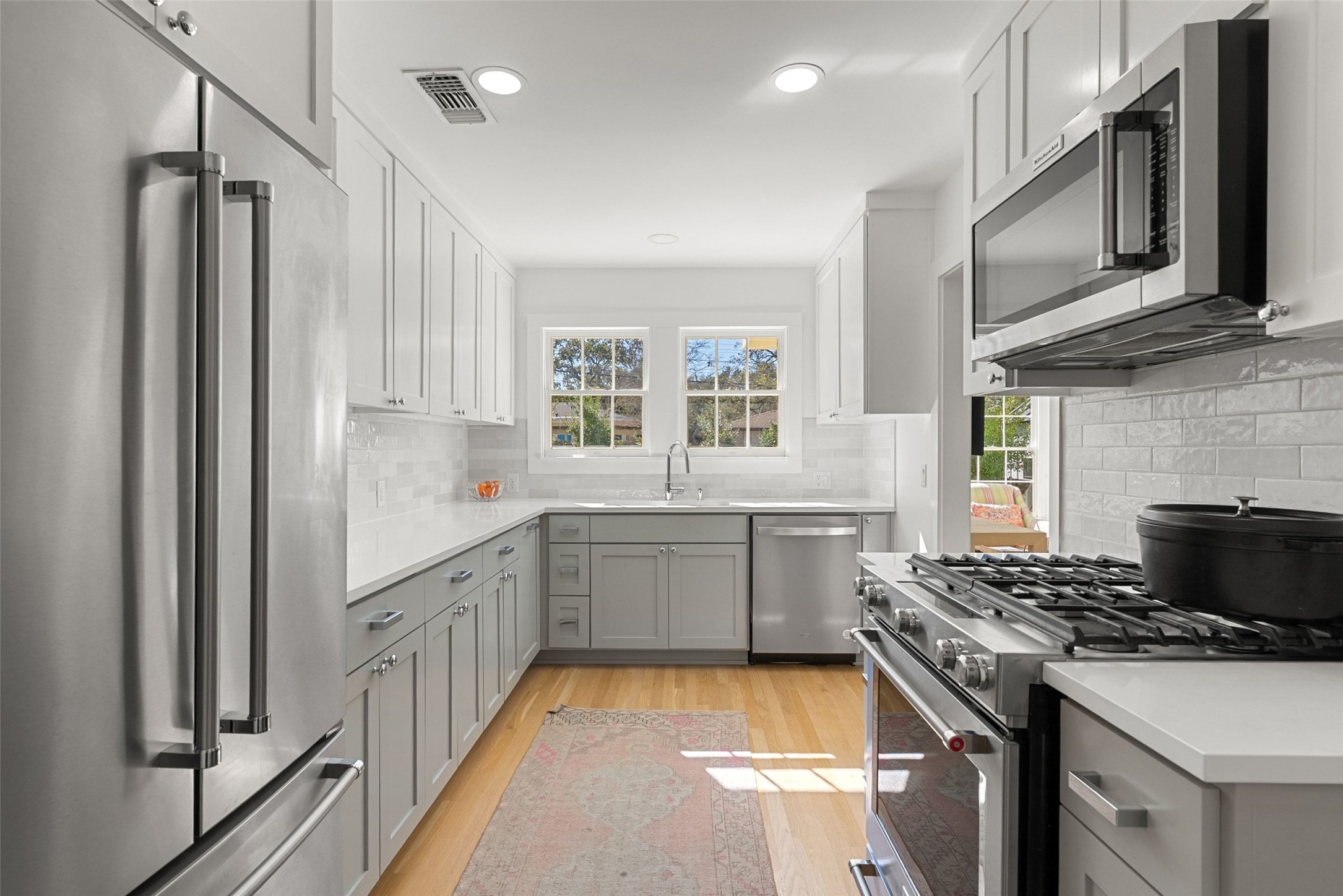 3311 Bonnie Road Austin, TX 78703 - Photo 17 of 40 a kitchen with a sink stove top oven and refrigerator