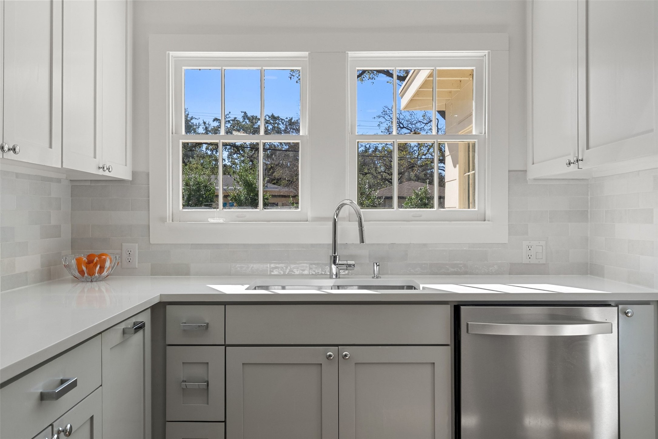 3311 Bonnie Road Austin, TX 78703 - Photo 18 of 40 a kitchen with stainless steel appliances granite countertop a sink window and cabinets
