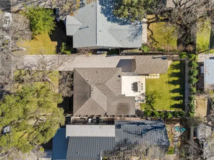 an aerial view of a house with a yard