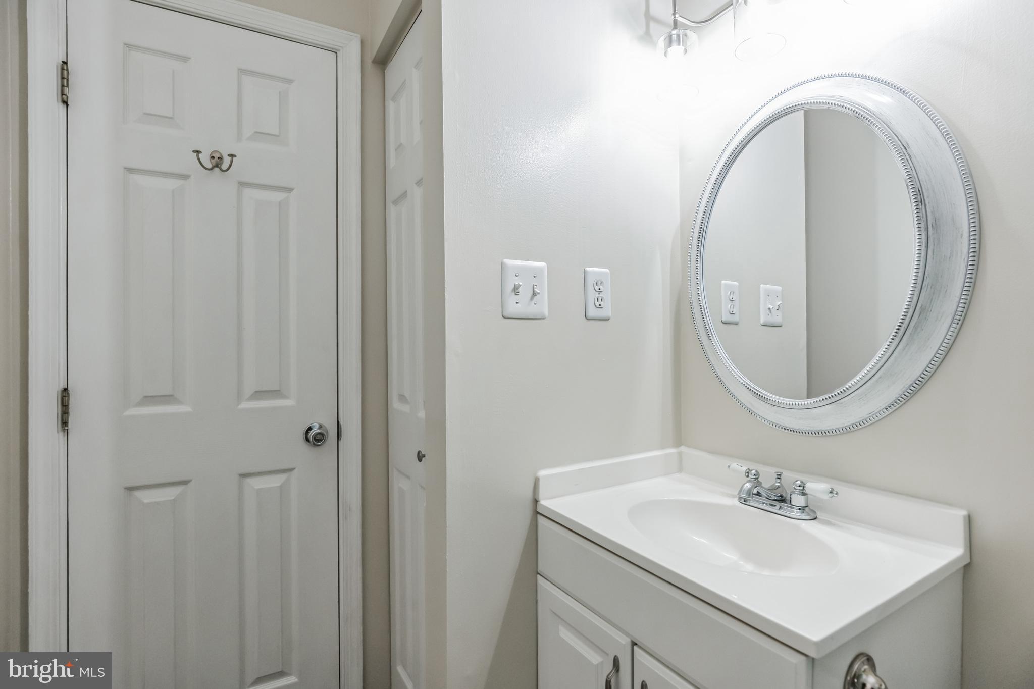 680 Small Reward Road Huntingtown, MD 20639 - Photo 17 of 40 a bathroom with a sink and a mirror