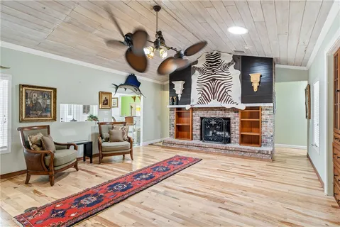 a living room with furniture a fireplace and a chandelier