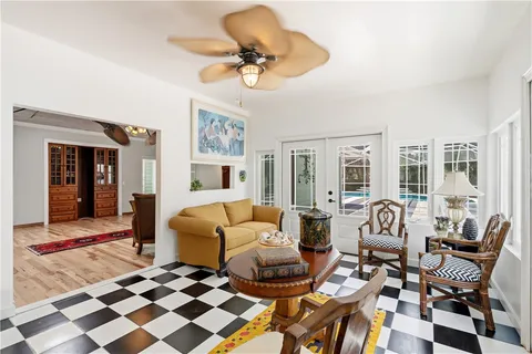 a living room with furniture and a floor to ceiling window