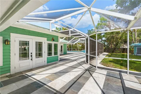 a view of a porch with a table and chairs