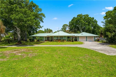 a front view of house with yard and green space