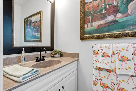 a bathroom with a granite countertop sink and a mirror