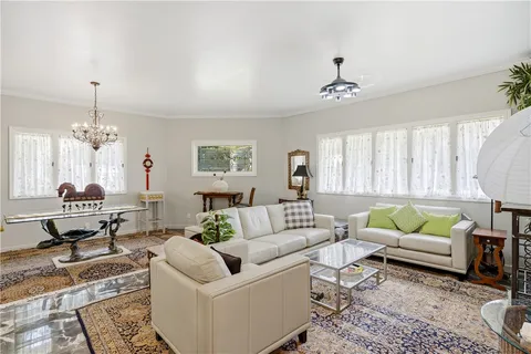 a living room with furniture or couch and a chandelier