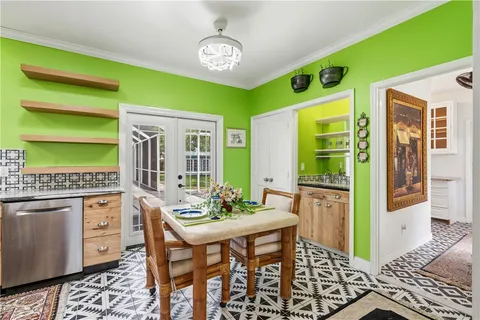 a dining room with furniture and a window