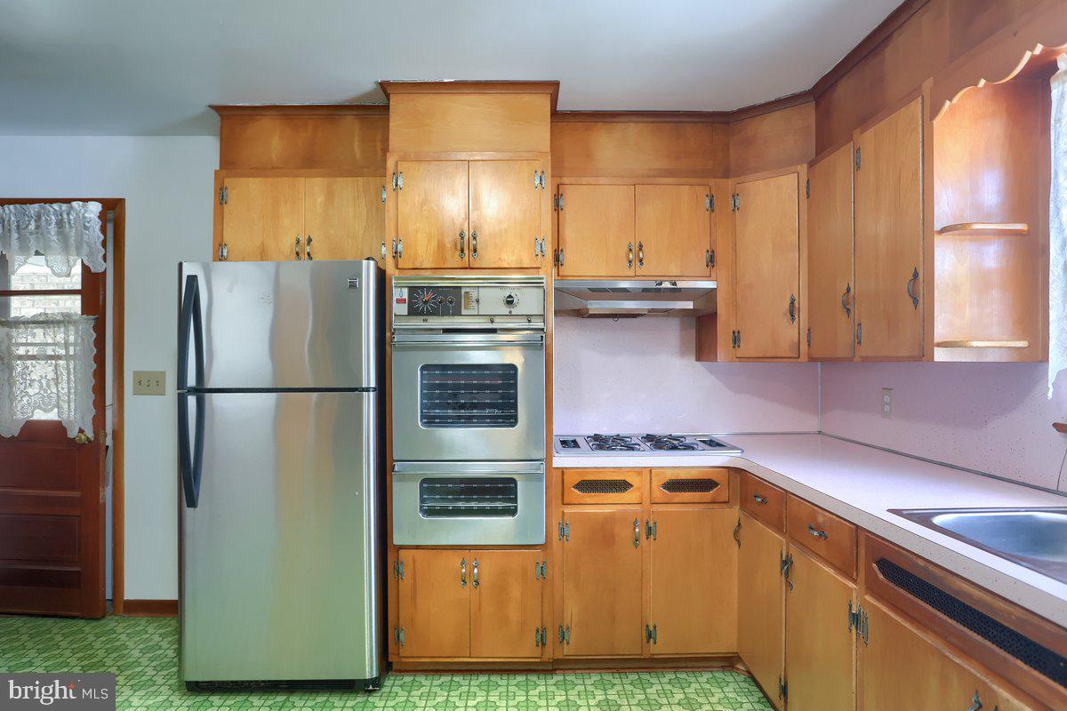 1910 Biglerville Road Gettysburg, PA 17325 - Photo 6 of 24 a kitchen with stainless steel appliances granite countertop a refrigerator a sink and a stove