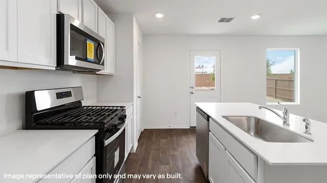 a kitchen that has a sink and a stove