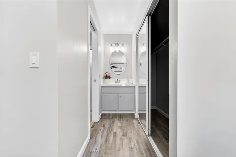 a view of a hallway with wooden floor