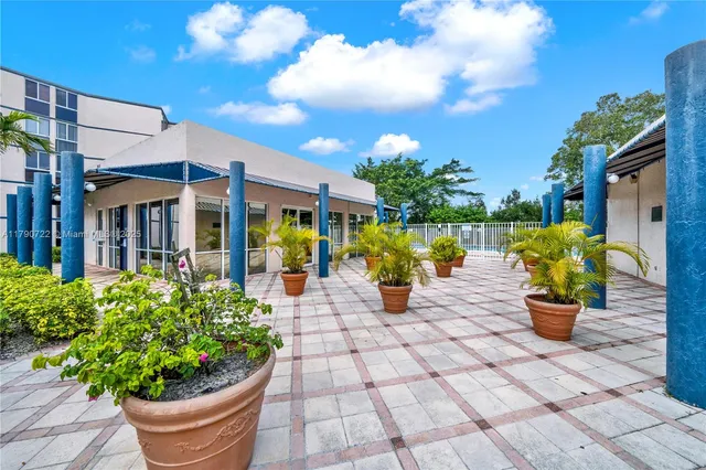 a view of a house with sitting area and potted plants