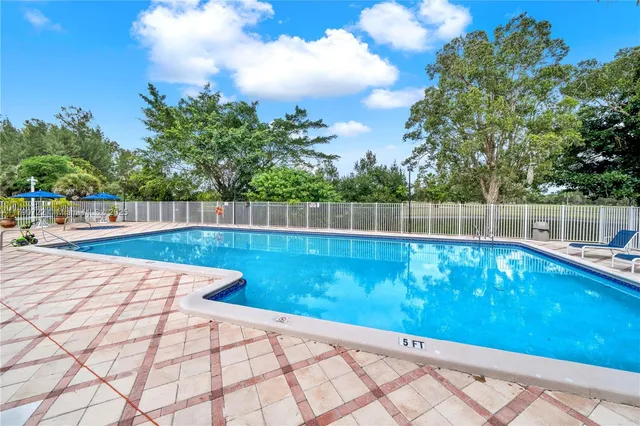 a view of a swimming pool with a yard
