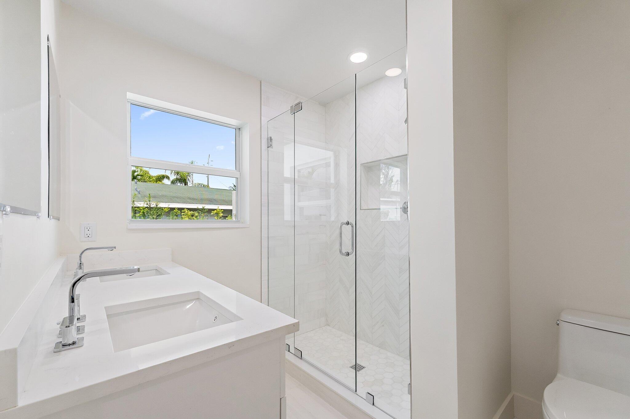 4015 Washington Road West Palm Beach, FL 33405 - Photo 18 of 31 a bathroom with a sink a toilet and shower