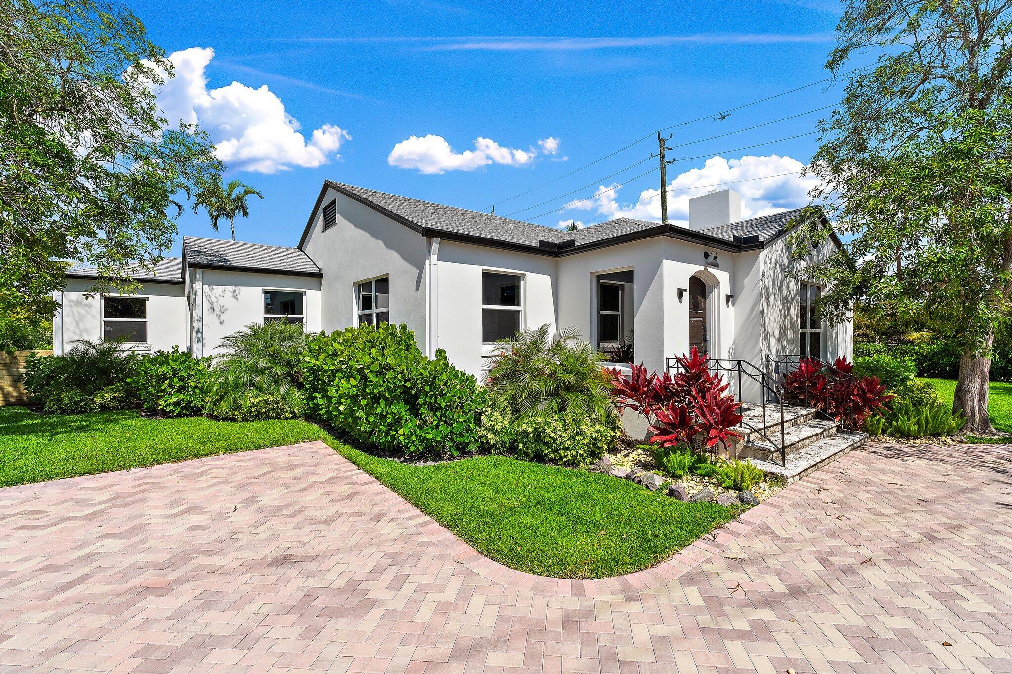 4015 Washington Road West Palm Beach, FL 33405 - Photo 2 of 31 a front view of a house with a garden