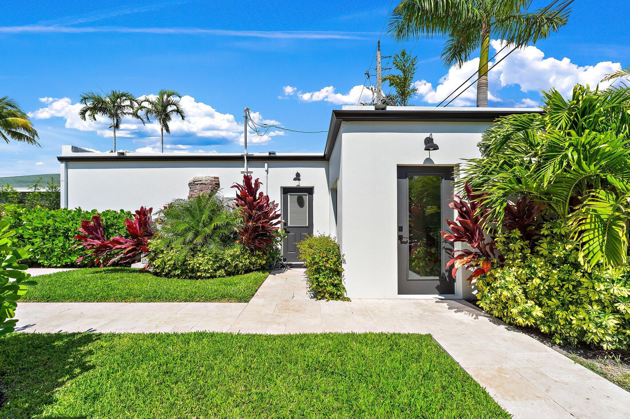 4015 Washington Road West Palm Beach, FL 33405 - Photo 26 of 31 a front view of a house with a yard and a fountain