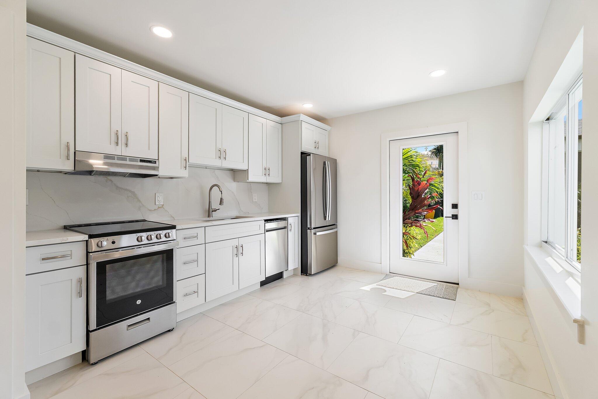 4015 Washington Road West Palm Beach, FL 33405 - Photo 27 of 31 a kitchen with stainless steel appliances granite countertop a refrigerator sink and stove