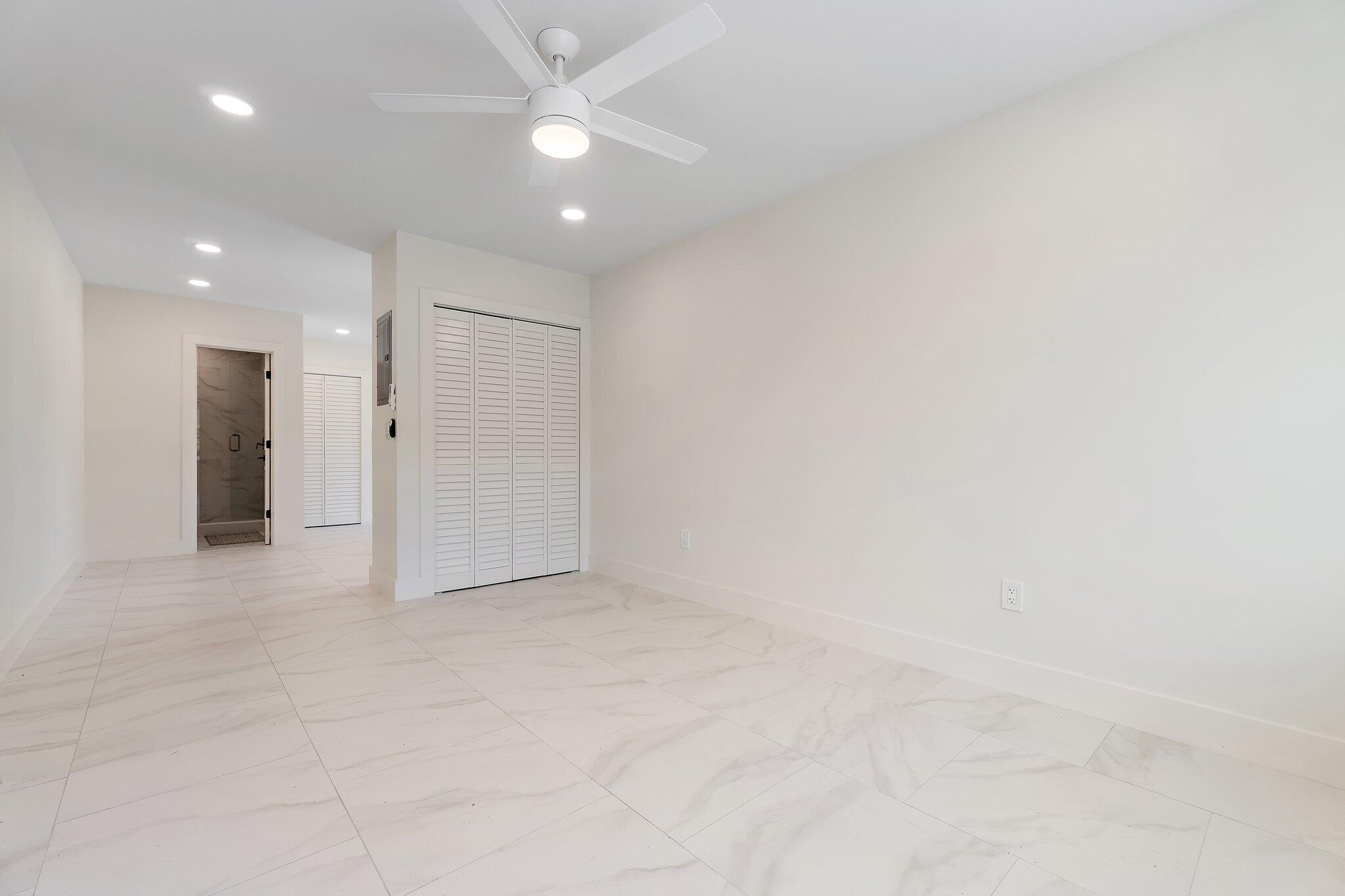 4015 Washington Road West Palm Beach, FL 33405 - Photo 30 of 31 an empty room with a ceiling fan and a bathroom