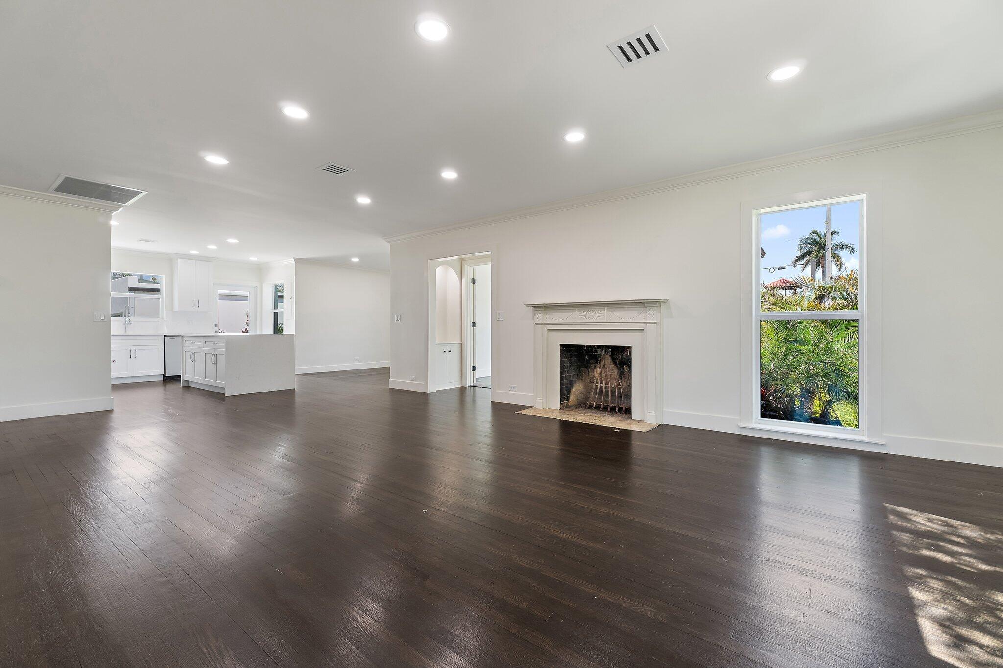 4015 Washington Road West Palm Beach, FL 33405 - Photo 5 of 31 an empty room with wooden floor fireplace and windows