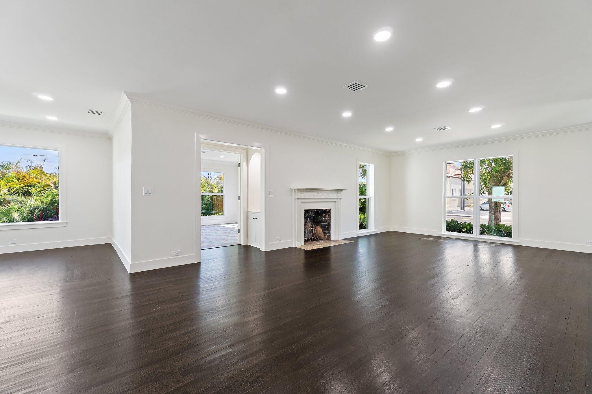 4015 Washington Road West Palm Beach, FL 33405 - Photo 6 of 31 an empty room with wooden floor and a fireplace