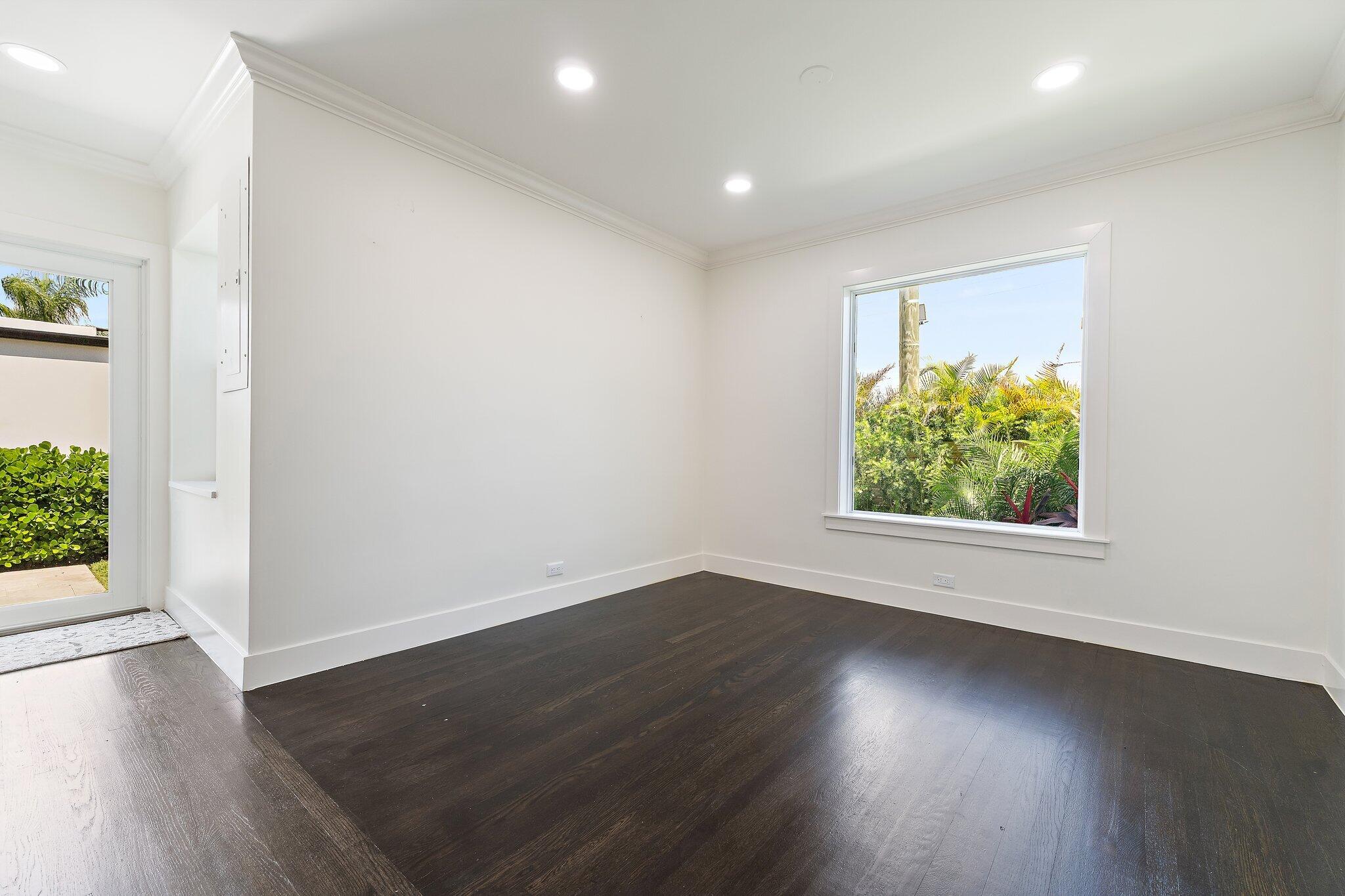 4015 Washington Road West Palm Beach, FL 33405 - Photo 9 of 31 an empty room with wooden floor and windows