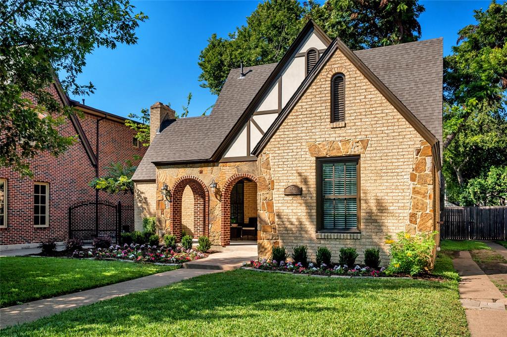 a front view of a house with a garden and plants