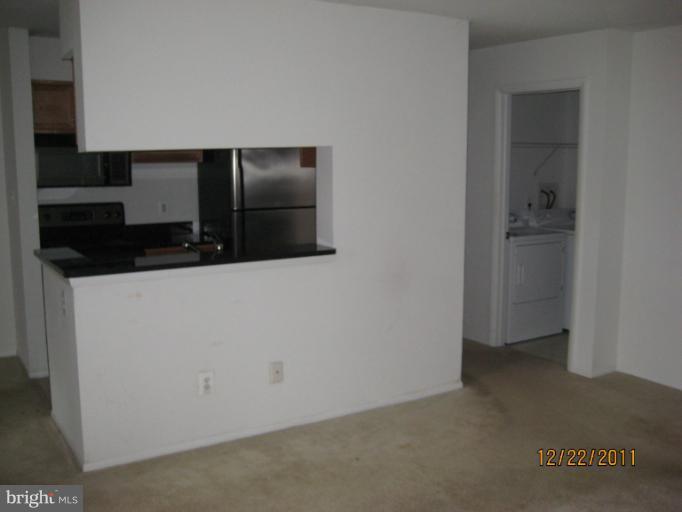 11703 Olde English Drive, Unit 11703A Reston, VA 20190 - Photo 14 of 19 a kitchen with a refrigerator and cabinets