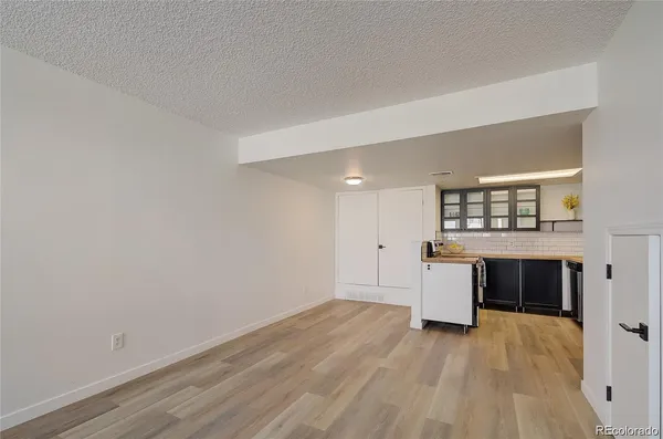 a view of empty room with a kitchen and sink
