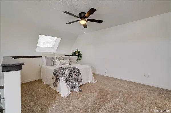 a bed room with a bed and a ceiling fan