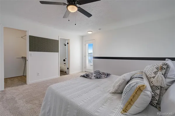 a bedroom with a large bed and a chandelier