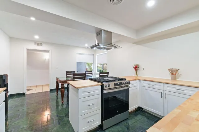 a kitchen that has a lot of cabinets in it