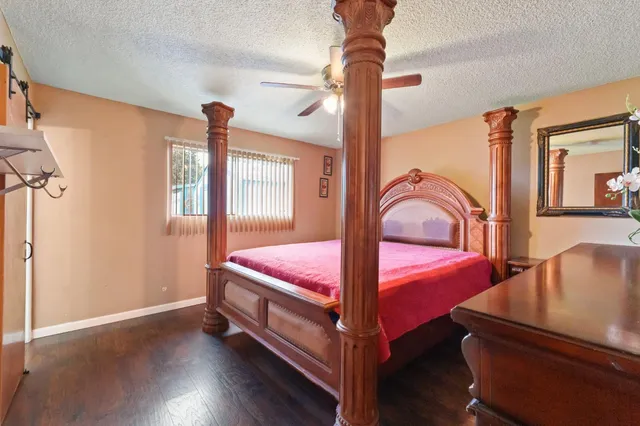 a bedroom with a bed next to a large window