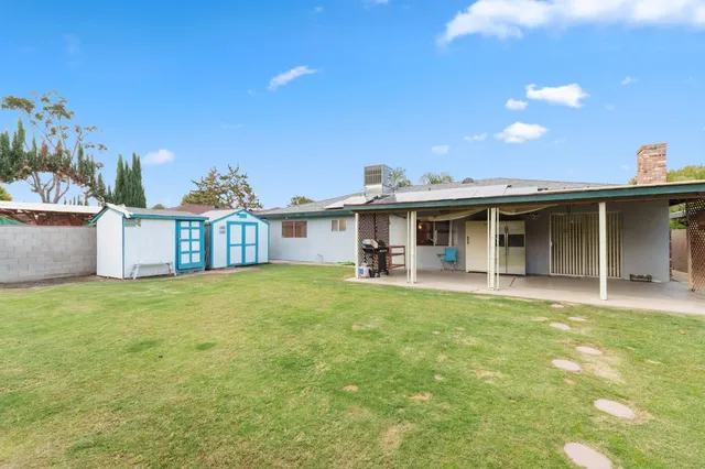 a front view of a house with a garden and yard