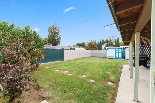 a view of a backyard with sitting area