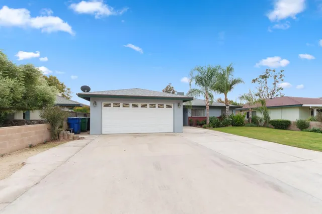a view of a house with a yard and garage