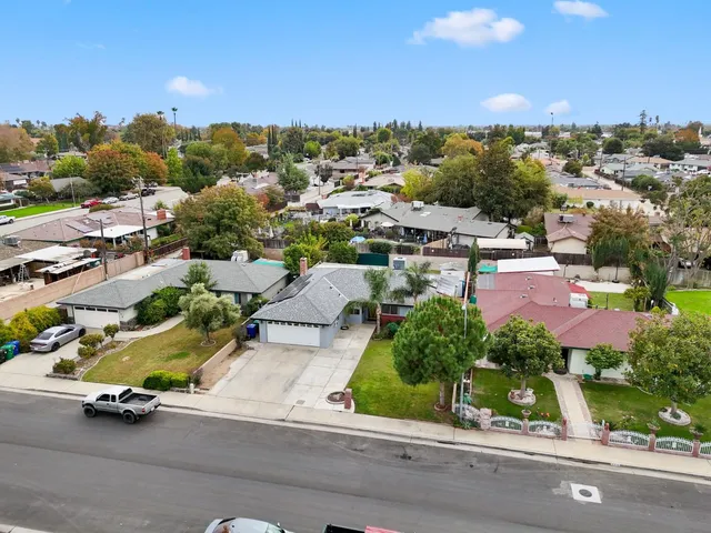 an aerial view of a houses with a street