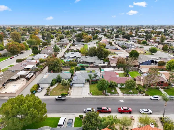 an aerial view of a houses with a yard