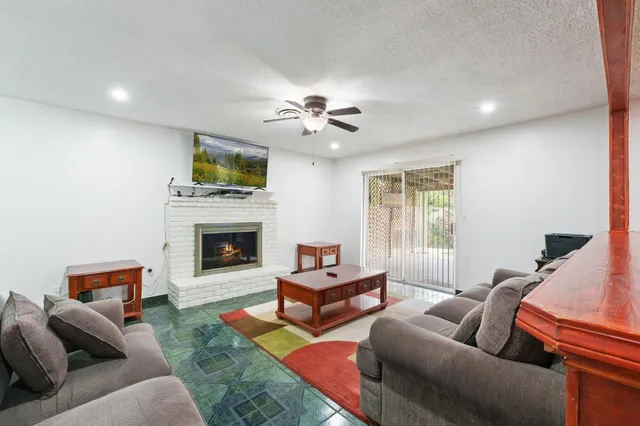 a living room with furniture a flat screen tv and a fireplace