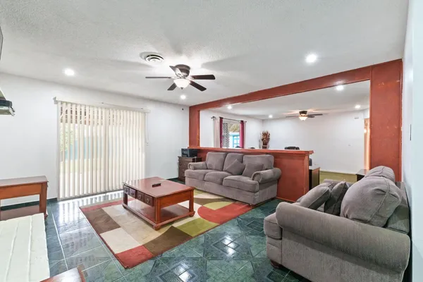 a living room with furniture a rug and a window