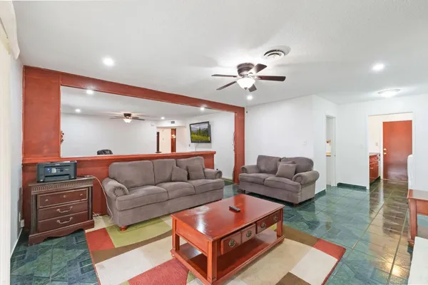 a living room with furniture and a chandelier