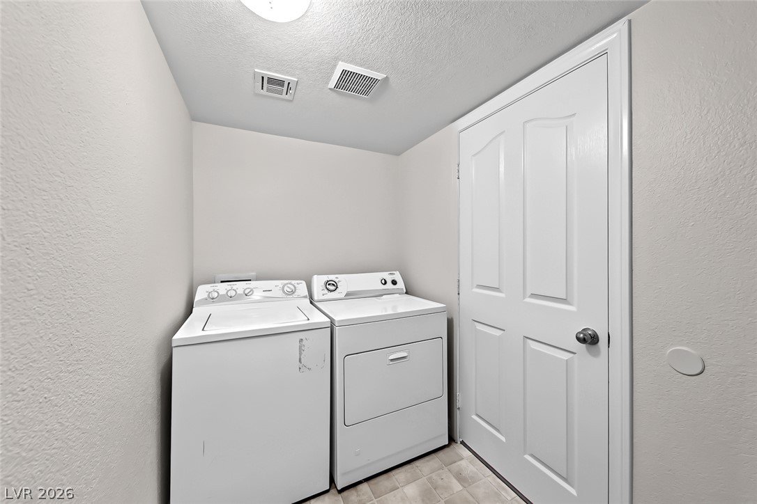 205 Genesee Point Street Henderson, NV 89074 - Photo 23 of 30 A dedicated laundry alcove features essential utility fixtures and hard surface flooring.