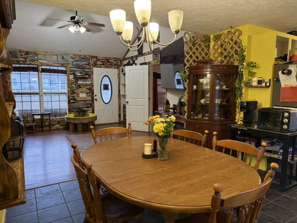 a kitchen with stainless steel appliances granite countertop a barbecue grill and cabinets