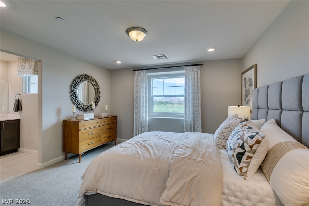 653 Pickled Pepper Place Henderson, NV 89011 - Photo 26 of 35 Naturally illuminated bedroom with expansive views, perfect for serene relaxation.