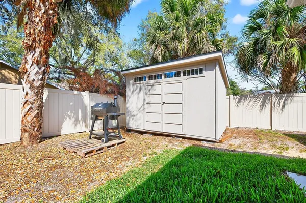 a backyard of a house with table and chairs
