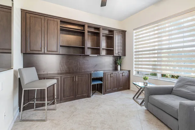 a bathroom with a granite countertop sink toilet and a mirror