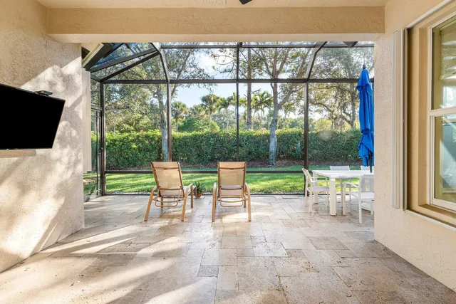 a view of a swimming pool with chairs in patio
