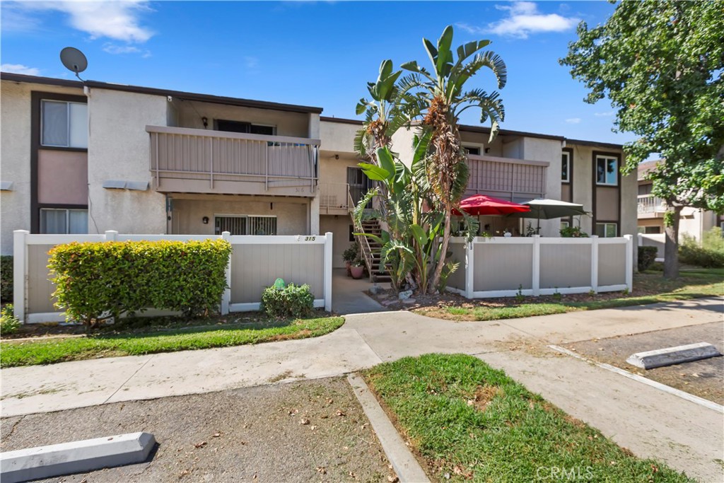 a front view of a house with a yard and a garage